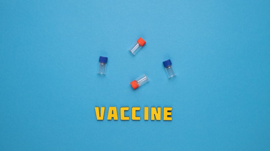 Three small vials and the word 'VACCINE' on a blue background.