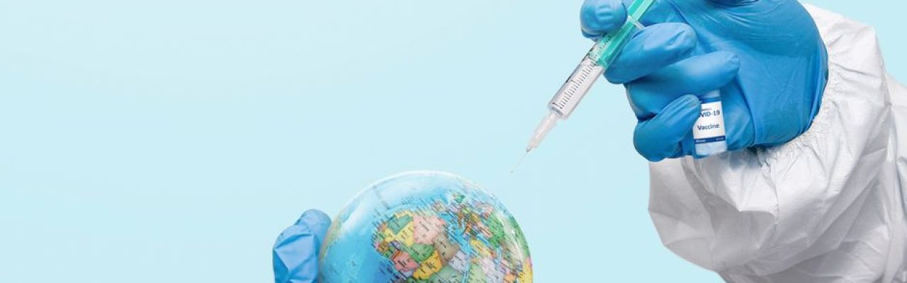 Hands in latex gloves injecting a globe with a syringe, symbolizing global vaccination efforts.