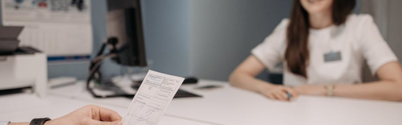 Woman doctor discussing patient's prescription in a clinic office setting.